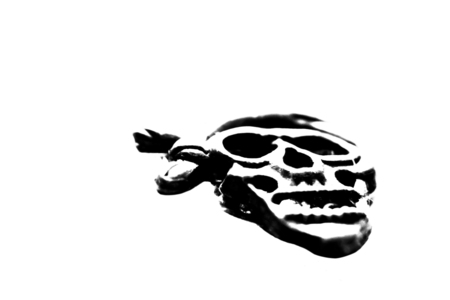 High contrast black and white silhouette of a pirate skull isolated on a white background.の写真素材