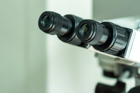 Black eyepieces of the microscope in the laboratory for viewing small items. Close-up.