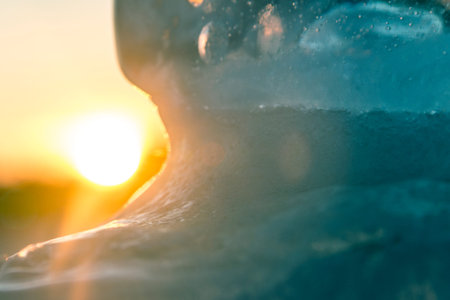 Abstract blurred background of an icy texture on the background of the sun. Cold.