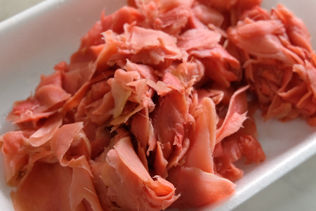 Ingredient of Japanese cuisine for sushi and rolls. Red pickled ginger close-up. Shallow depth of field.の写真素材