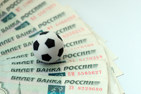 A soccer ball on Russian banknotes with a face value of one thousand rubles. The concept of corruption, bribes or sports betting.の写真素材