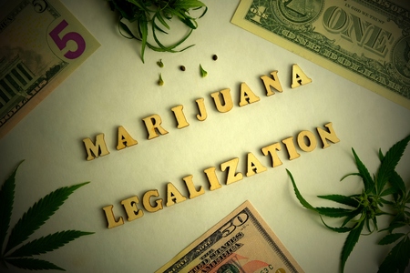 LEGALIZATION MARIJUANA frame with an inscription of wooden letters. Cannabis and one, five, fifty US dollars. Concept drugs and money.の写真素材