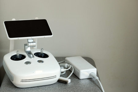 White control panel from the aircraft drones with a monitor and joysticks connected on the charge....