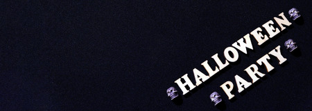 An inscription from wooden letters for Halloween. On a black background.の写真素材