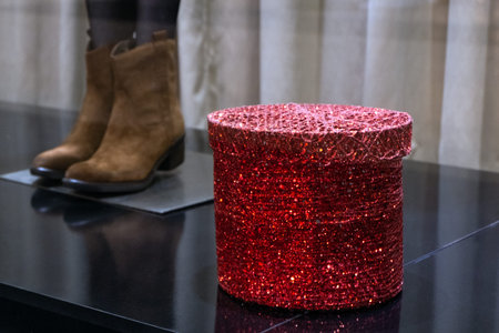 A pair of women's shoes and a shiny red box on the storefront. The concept of holiday sales or...