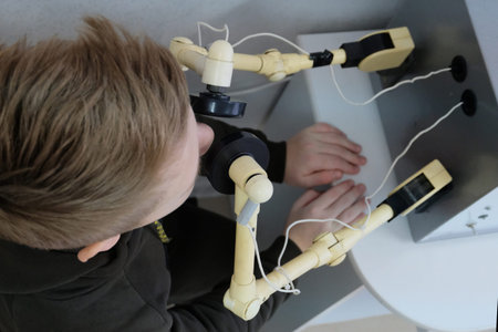 A teenager on a physiotherapy procedure warms up the nose on the UHF apparatus in the hospital....
