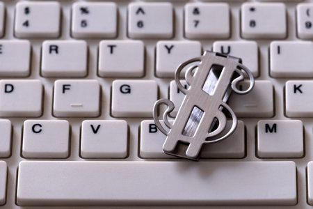Metal clip waiting to be denominated in the form of the US dollar. Closeup of a part of a white...