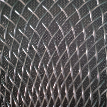 Microphone grid. Close-up. Background of twisted steel wire. Patterned texture of metal. Macro...