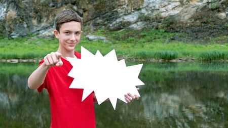 You are ready to get a discount? A smiling teenager in a red T-shirt holds a white star in his hand. Template for mockup. The concept of sales and black friday.の写真素材
