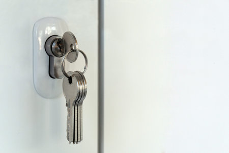Mortise lock in a plastic door. A bunch of new keys. Opening or closing a room or the Concept of...
