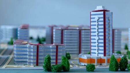 Project of modern urban houses and streets in an abstract city. Toning, macro photography, shallow depth of field. Background to illustrate mortgage lending and new home construction. Selective focus.の写真素材