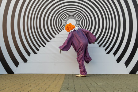 A man in a clown costume pretends to be climbing stairs. Hypnotic effect and optical illusion. 3d...