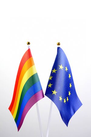 EU and LGBT. Two table flags on a white background. The concept of a meeting of European people with representatives of non-traditional sexual orientation. Copy space.の写真素材