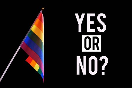 LGBT rainbow flag and the inscription "Yes or No" on a black background. The concept of permission and prohibition, propaganda and choice, community of sexual minorities and non-traditional orientations.の写真素材