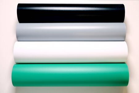 PVC Matte Reflective Dual Side Photography Backdrop Background Paper. Four rolls in a row black, gray, white and green colors.の写真素材