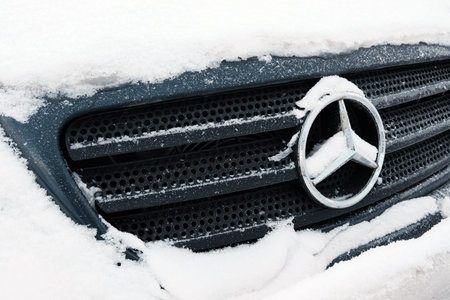 Kazakhstan, Kostanay, 2019-01-19. Mercedes iconic logotype covered with snow flakes. Winter....