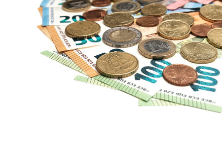 Euro coins and cents lie on the banknotes. Background of european money. Banknotes of one hundred,...