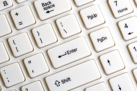 Part of a white keyboard for a computer. Enter key close up. The concept of social networks and information communication. Background for digitalization design and computer literacy.の写真素材