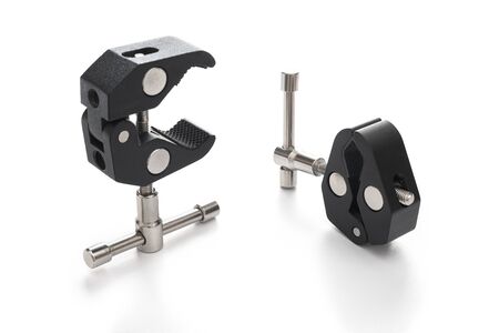 Two Super Crab Clamp for DSLR or mirrorless Camera in closed and open form. Strong construction, made of stainless steel and aluminum alloy with 1 4 and 3 8 inch thread holes. White background with texture. Not isolated.の写真素材