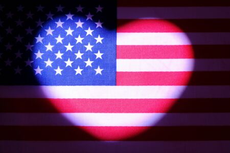 Heart symbol on usa flag. Symbol of patriotism, love and freedom. The concept of American independence and the celebration of Valentine's Day. Dark background.の写真素材