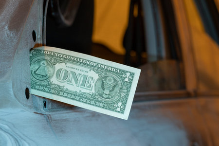 One dollar bill instead of a mirror on a car door. Poverty and cheap wages in the automotive service...