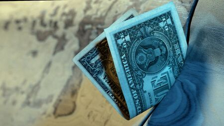 One dollar bill stuck in the gap of an unrepaired car. Close-up. Poverty and cheap pay in a car service station. Low paid wage labor. A scratched metal surface is prepared for repainting. Blue tone.の写真素材