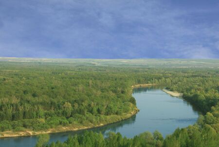 Beautiful landscape. Wood, river and blue skyの写真素材