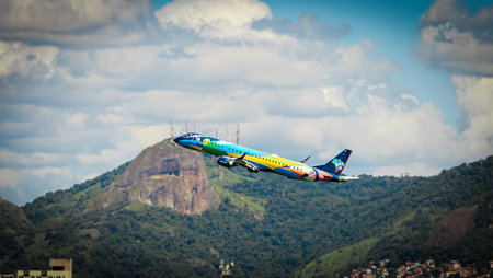 Vitoria / Brazil - April 10 2021: Side view of AZUL AIRLINES Embraer 190 takeoff run Vitoria Airport (VIX / SBVT). Eye rock in the background.のeditorial素材