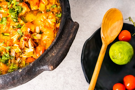 Delicious Brazilian fish moqueca with tomato, onion, olive oil, coriander and orocum seed. Made in...