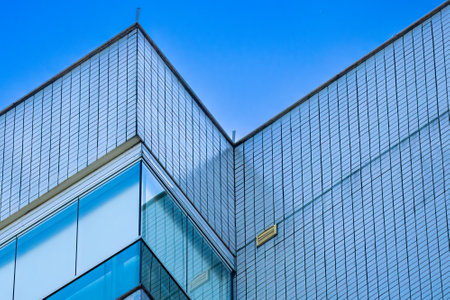 Detail of the top of a residential building showing details of the geometry of the balconies and glazing.の写真素材