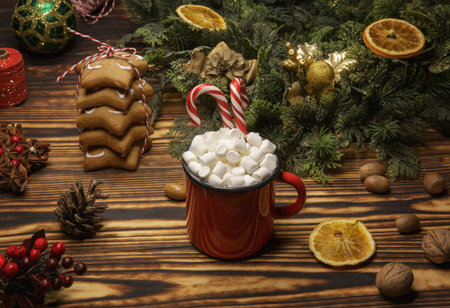 red mug with cocoa and marshmallow and Christmas cookies on a wooden table
