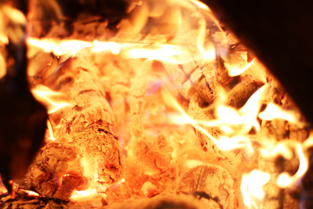 Burning log fire in night heat fireplace. Closeup flame. Barbecue coal blazingの写真素材