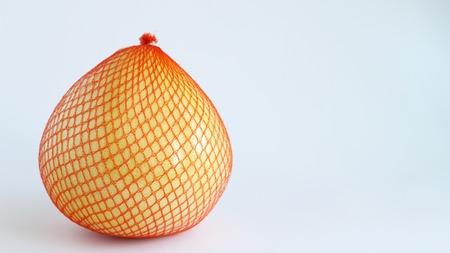 Citrus maxima. Pomelo fruit on white background. Pomela in orange gridの写真素材