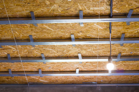 Installation of wiring in profile for drywall. Unfinished ceiling skeleton