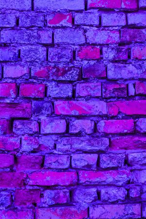 Pink and purple brick wall backdrop. Architecture facade texture. House interior backgroundの写真素材