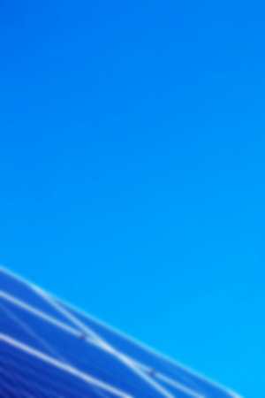 Solar panels and blue sky blurred background. Sunlight clean energy power. Renewable green cheap...