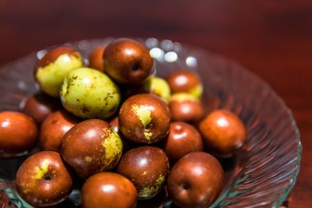Fruit, jujube ball brown color green. The plate glass ready to eat. Chinese people eat fruit.の写真素材