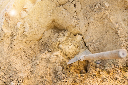 Shovel that was on the sand. Who are going to lap up the construction material.の写真素材