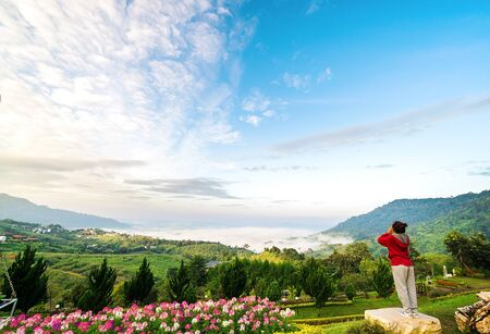 girl standing yelling for nature. Sense of relief well release bad things out and make us feel good. And nature brings sorrow away.の写真素材