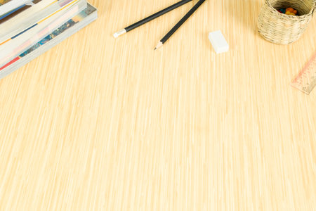 Wooden floor with space and decorated with stationery and books.It is about education, and can be...