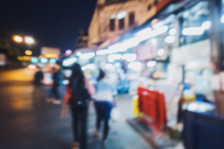 The image is blurred in the city, and there are people on the move.Suitable for use as a background image, the feelings of chaos in the night and diversity and as a backdrop.の写真素材