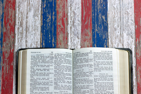 An open Bible against a July 4th red, white and blue background