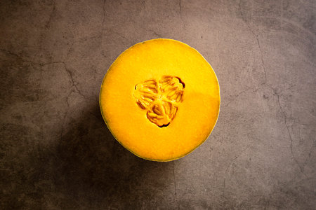 Fresh Cantaloupe on a Brown Cement Textured Background with room for text