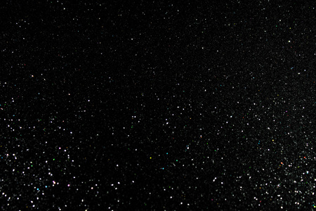 Glittering fashion black background with twinkling grainy textureの写真素材