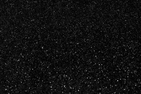Glittering fashion black background with twinkling grainy textureの写真素材