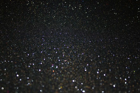 Black glitter background with christmas lights.の写真素材
