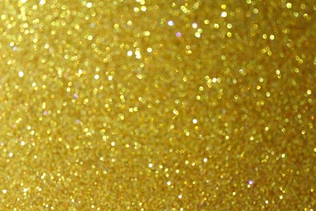 Gold glitter particles textured backgroundの写真素材