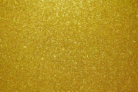 Gold glitter particles textured backgroundの写真素材