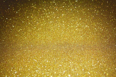 Gold glitter particles textured backgroundの写真素材