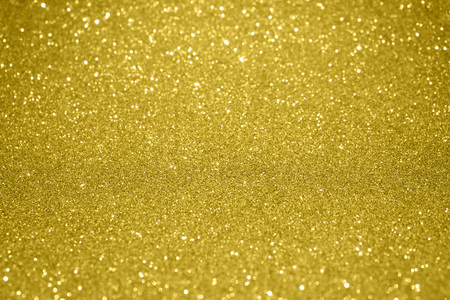 Gold glitter particles textured backgroundの写真素材